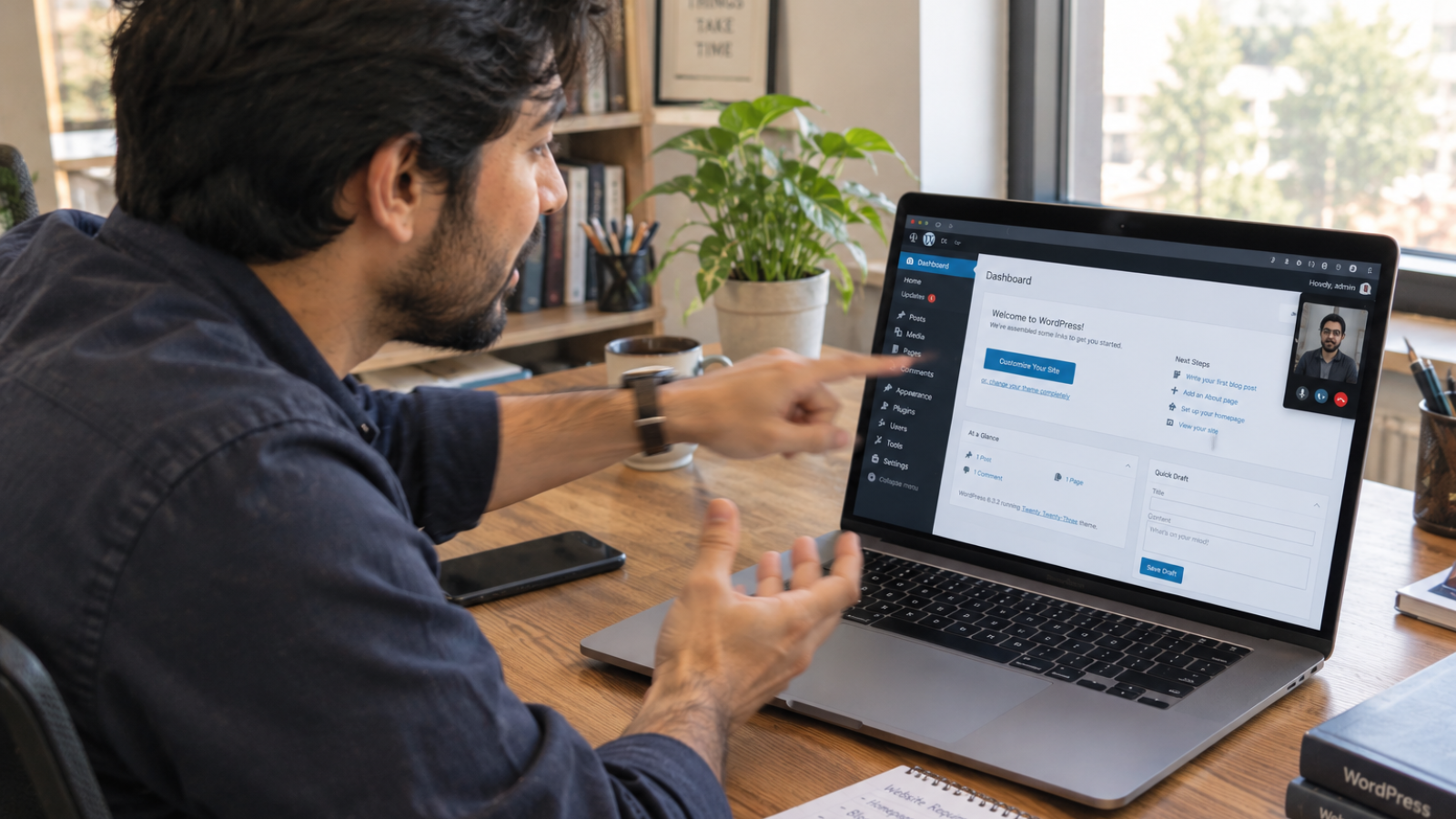Business owner pointing at a laptop while preparing to hire a freelance WordPress developer